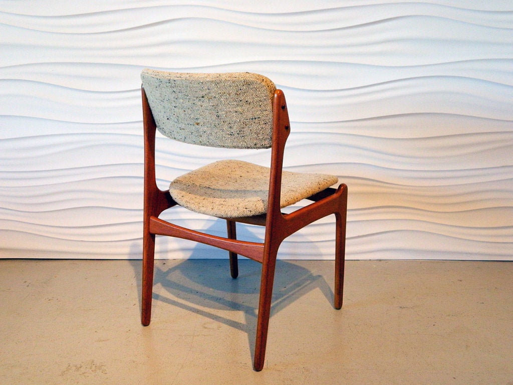 Pristine set of eight teak dining chairs by Danish designer Eric Buck. Original oatmeal wool upholstery