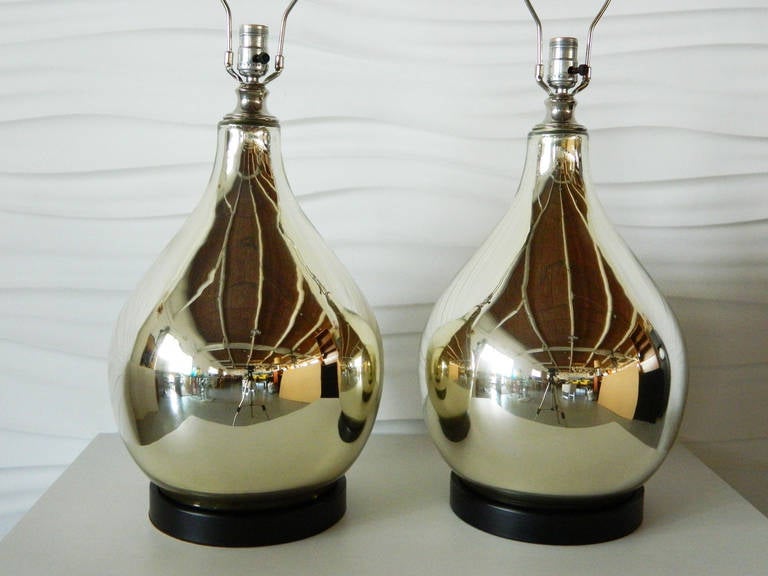 Handsome pair of large, mirrored glass lamps by Speer. The lamps have black-painted finials.