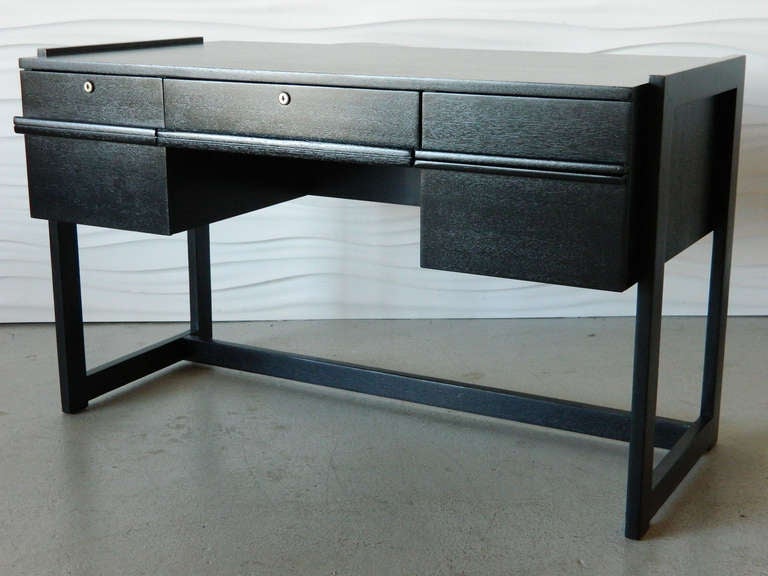 Designed by Paul Laszlo for Brown Saltman California, this desk was recently restored with a black painted finish. There is a key for the  desk.