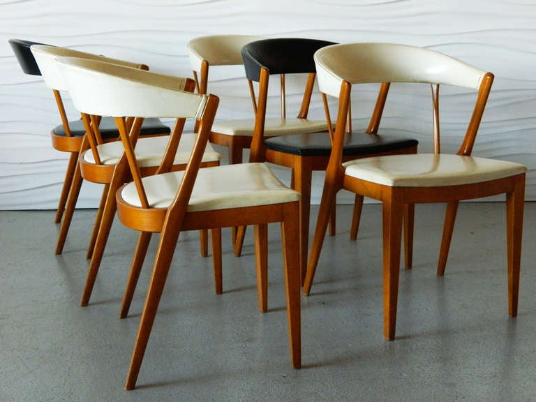 Set of six wood dining chairs attributed to Folke Ohlsson for DUX/Sweden. Two are covered in black vinyl and four are covered in white upholstery.