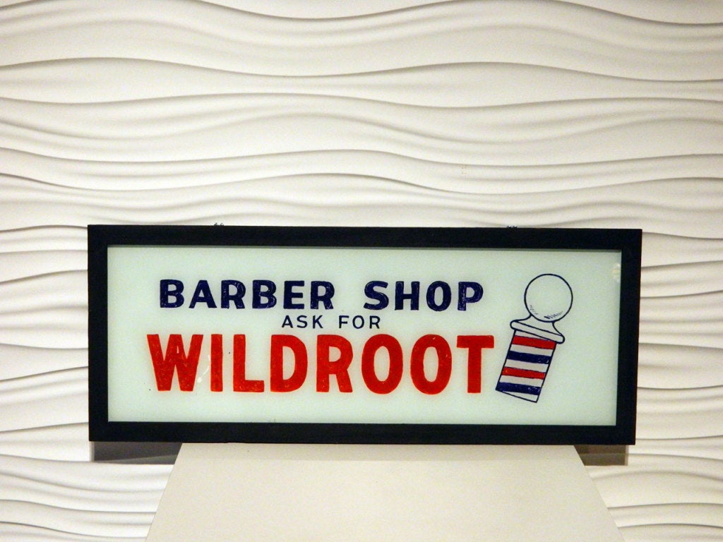 Vintage reverse-painted glass barber shop sign. Framed in wood and ready to hang.