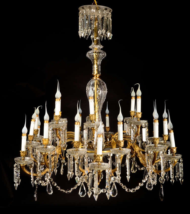A spectacular & Large Antique French Baccarat Louis XVI gilt bronze, cut crystal & frosted crystal triple tier multi light chandelier of fine craftsmanship embellished with cut crystal chains, prisms, bolbeches & further adorned with a round frosted