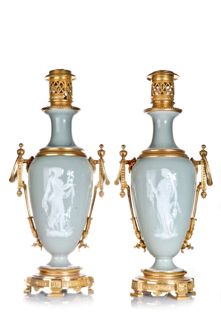 A PAIR OF EXQUISITE ANTIQUE FRENCH NEOCLASSICAL GILT BRONZE MOUNTED CELADON & PAT SUR PATE ENAMELED PORCELAIN LAMPS, EACH LAMP IS EMBELLISHED WITH HAND ENAMELED PATE SUR PATE DECORATION DEPICTING NEOCLASSICAL FIGURES & MOTIFS,CA.1870. 