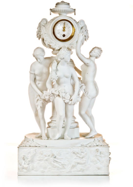 A Rare  Antique French Louis XVI gilt bronze mounted white bisque porcelain figural clock depicting the three graces with floral wreaths posing around a column,Ca.1880's.