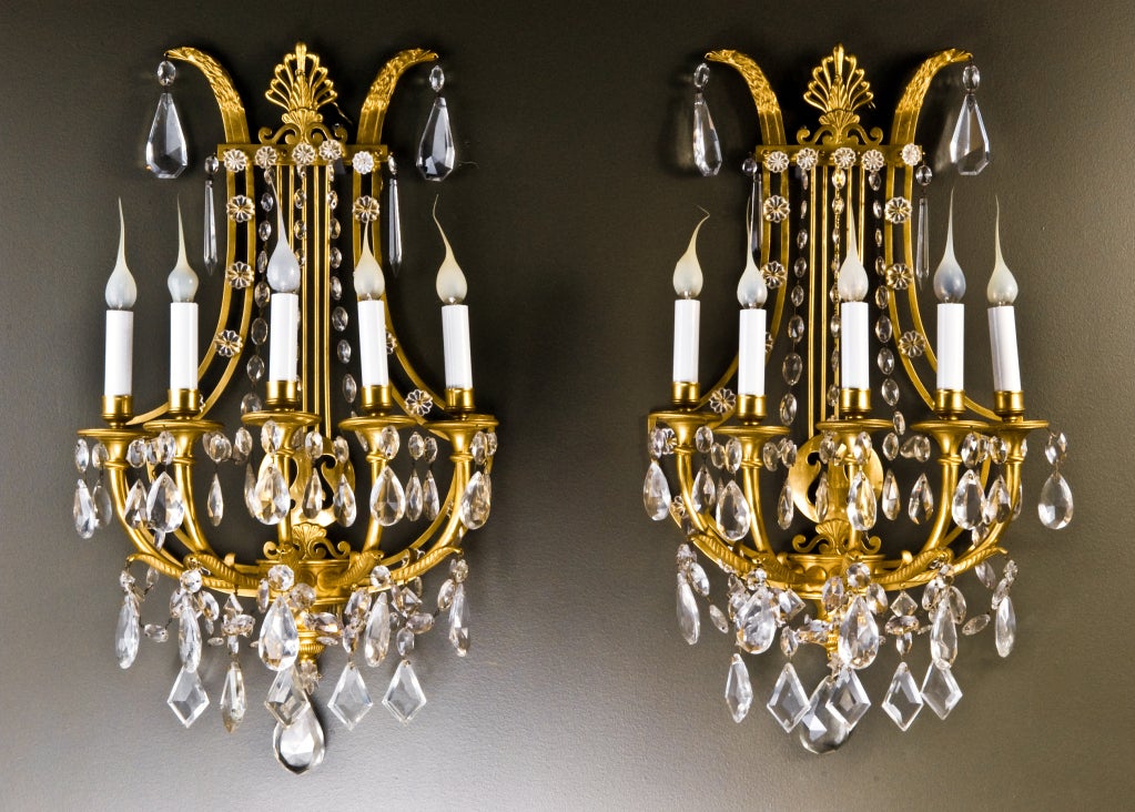 Pair of Sensational Antique French Louis XVI gilt bronze & cut crystal multi light lyre form wall sconces embellished with exquisite cut crystal chains, prisms & further adorned with neoclassical eagle heads, Ca. 1860's.
