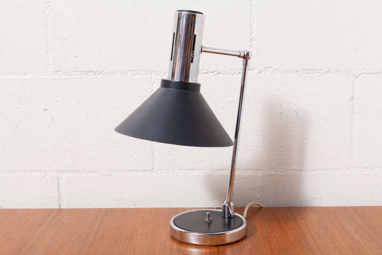 Drafting style enameled black metal and chrome desk lamp with weighted base. In Original Condition with Wear Consistent with its age. 
