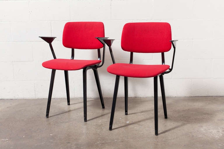 Original upholstered Revolt chairs in red with black enameled sheet metal frame and molded acrylic arm rests in good original condition.  Armless side chair also available, listed separately.