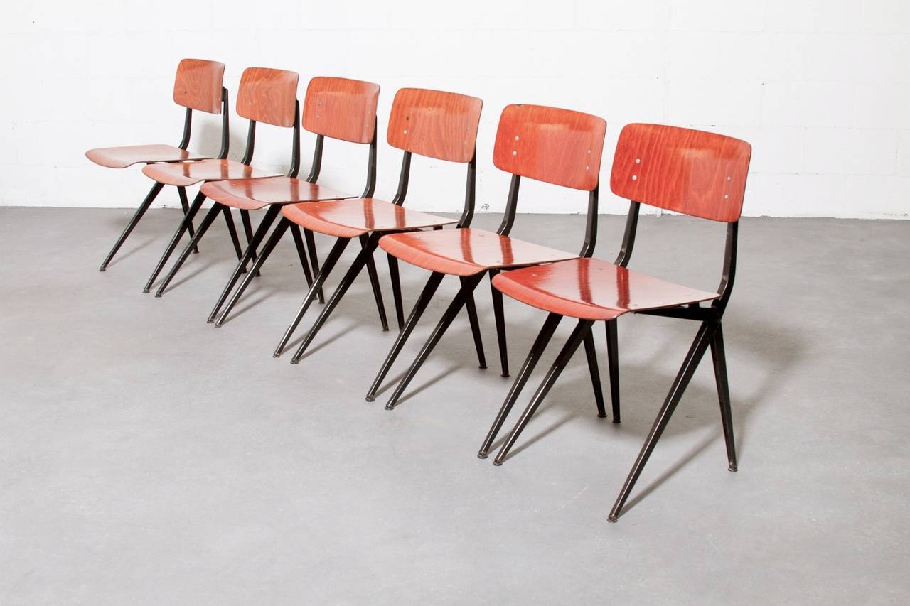 Beautifully Aged Friso Kramer Style Result Chairs with Black Enameled Metal Frame. Plywood Color Varies from Brown to Reddish Brown. Visible Wear to Metal Legs, Warm Patina to the Plywood Seating, and Chip to One Seat Back. Set Price.