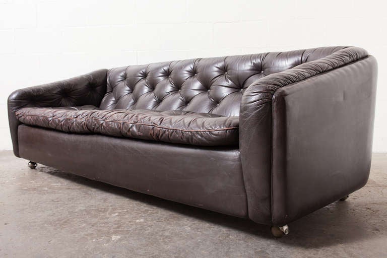 Long dark chocolate brown leather sofa with great patina.  In original condition.