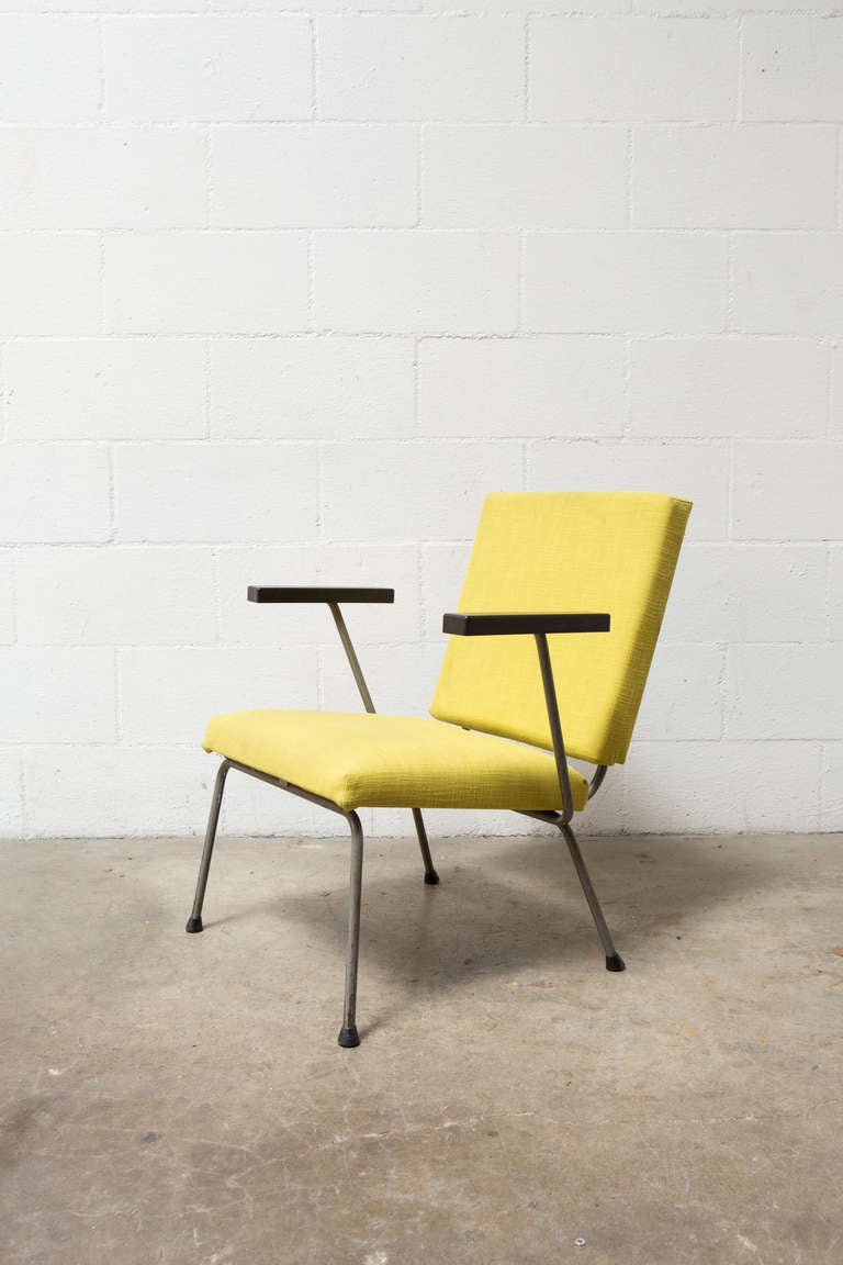 Original enameled grey steel frame with bakelite armrests and upholstered in original lemon/lime shade fabric.