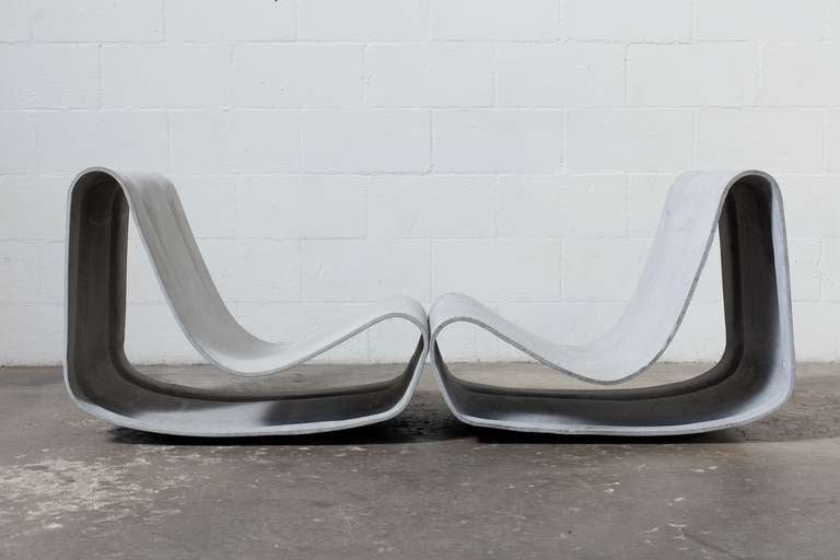 These modern and distinctive Willy Guhl Loop Chairs are made of eternit- a light gray, cellulose-infused, nearly indestructible fiber-cement. Perfect for indoor or outdoor use, these lightweight chairs are built to withstand sun, rain or snow. Set