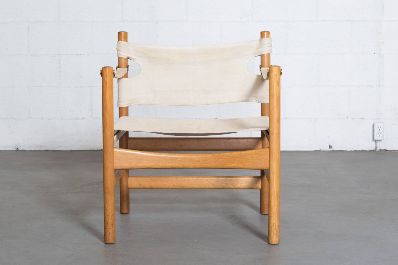 Børge Mogensen's iconic style shines through in the construction of his #2231 solid white oak frame chair. The original canvas seating with the cut-outs in the seat back make way for the brass hardware while maintaining the natural and easy feel of