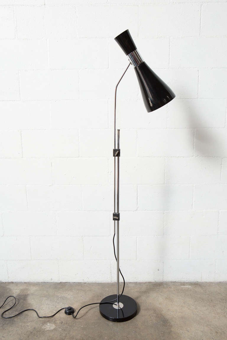 Mod 70's designed Adjustable Height Floor Lamp with Black Enameled Shade, Chrome and Black Enameled Metal Base. Some Cracking to Plastic Hardware. Some rusting and Chrome Loss to Stem. Height Extends up to 82