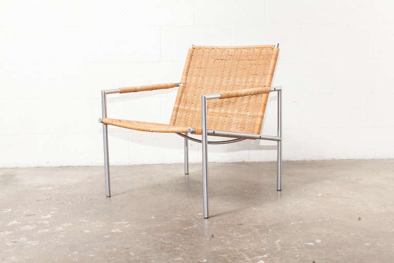 One of Martin Visser's well-known Easy Chair Designs of the 1960's - Lounge Chair with Tubular Chrome Metal Frame and Woven Rattan Seat and Back, with Rattan Wrap Detailing on Arm Rests.

Martin Visser began working for Spectrum in 1954 as