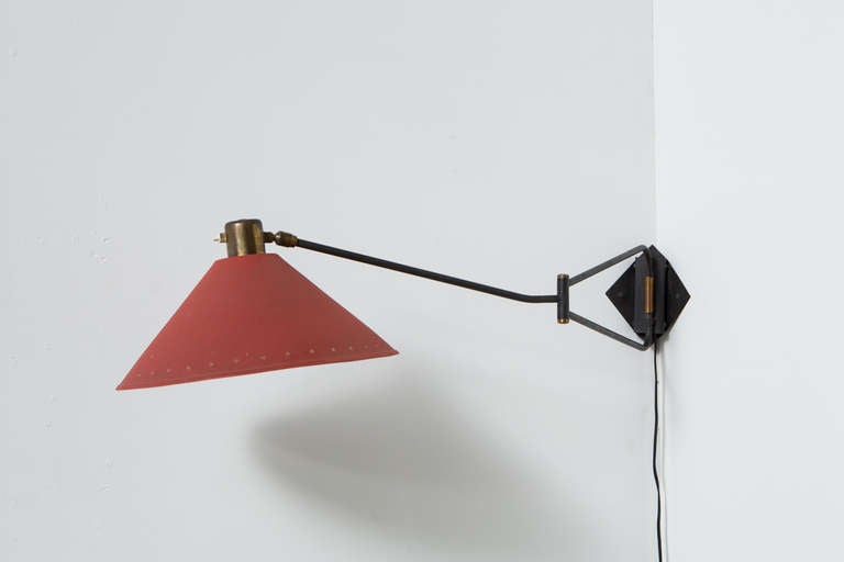Beautiful Corner or Wall Lamp with Enameled Red Metal Shade, Star Cut-Outs. Black Steel Articulating Arm with Brass Hardware. Folded Corner Plate.