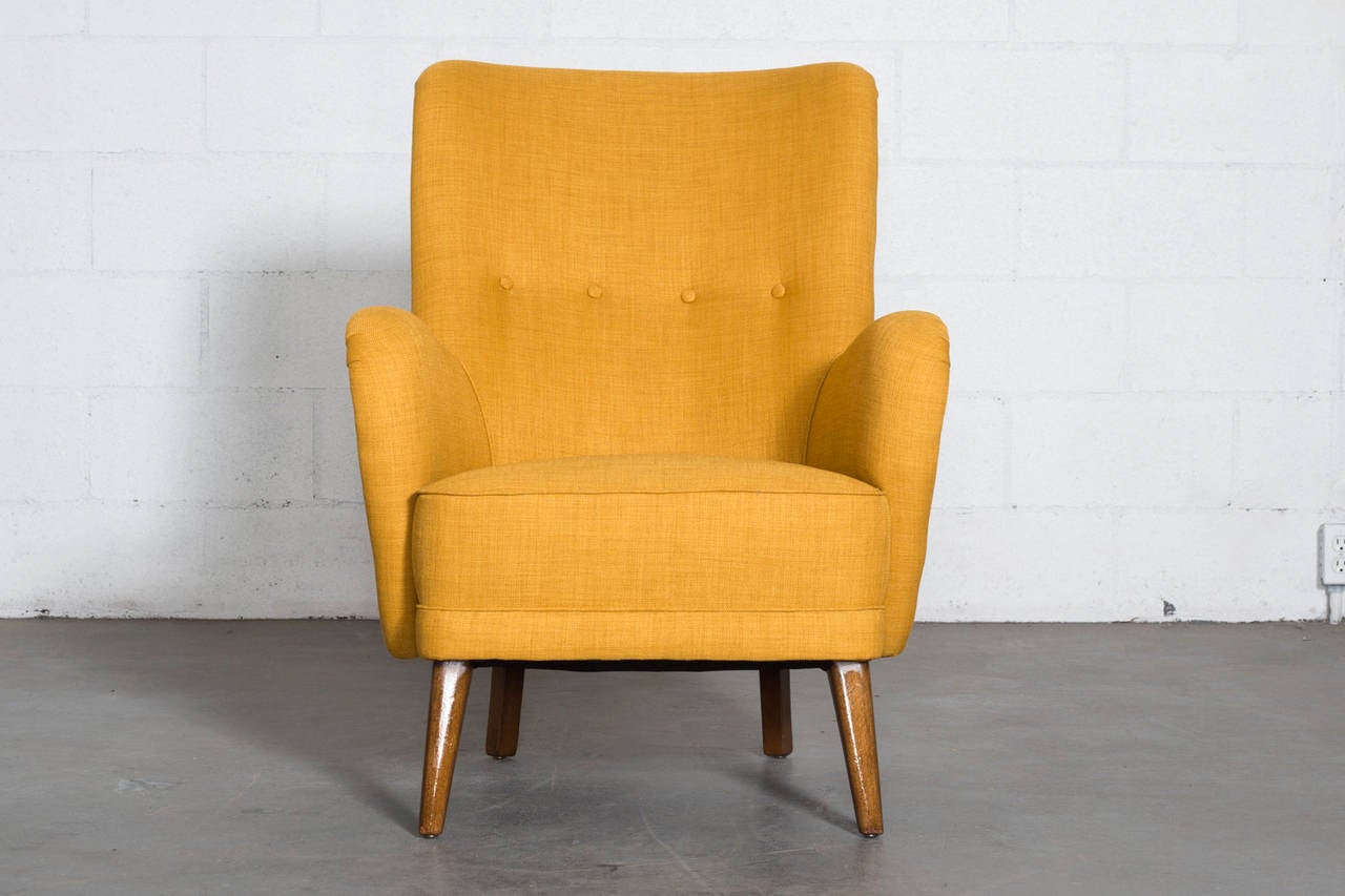 Handsome Theo Ruth Armchair with Tapered Wood Legs and New Mustard Yellow Upholstery. In Very Good Condition with Light Wear to Legs.

Theo Ruth was an interior and furniture designer whose most famous design was his 1952 Congo chair based on
