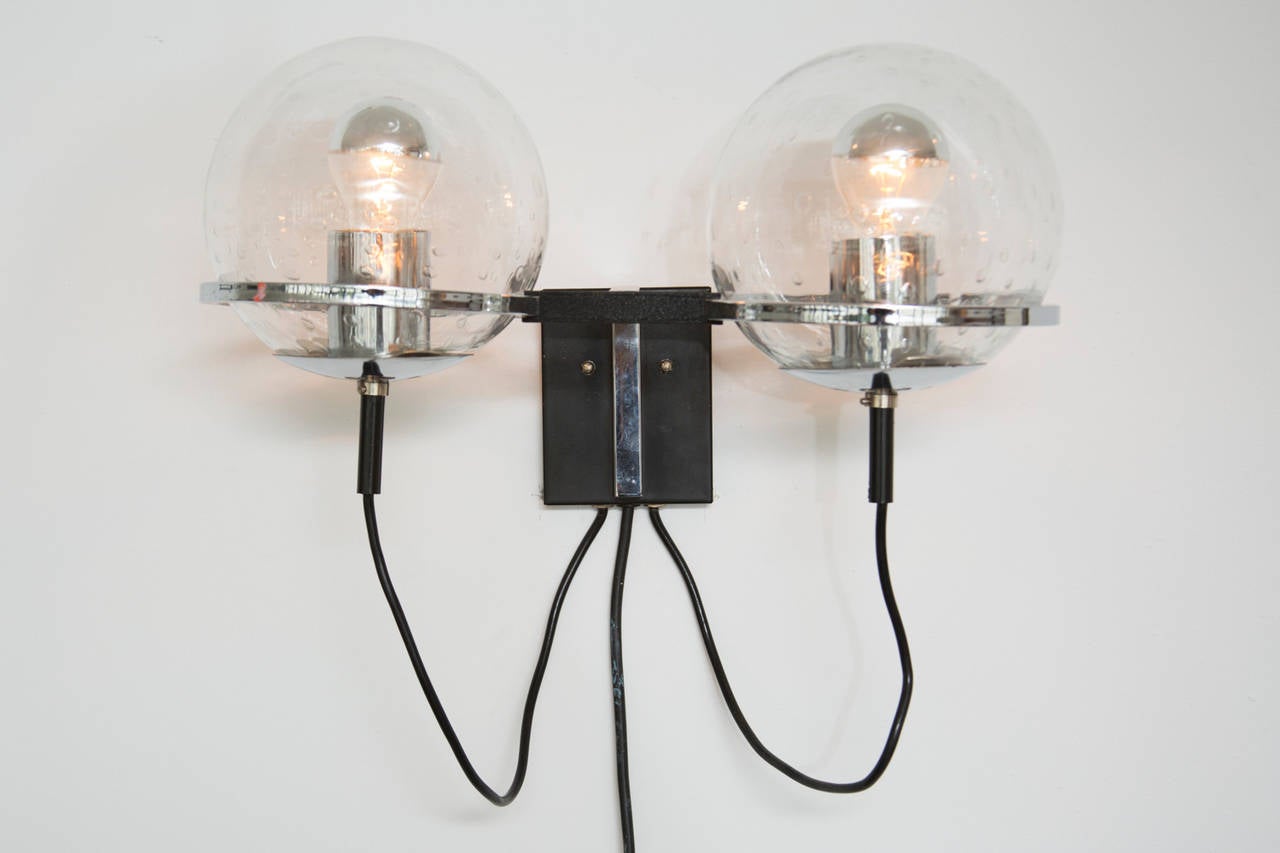 Stunning pair of RAAK wall lights with double, bubbled glass globes, black enameled base, and chrome accents. Two double-globe sconces, set price.