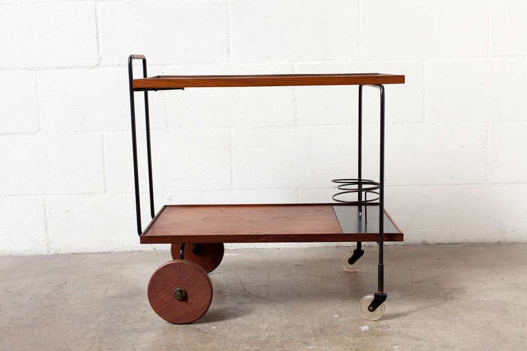 Two Level 1950's Teak and Formica Rolling Bar Cart with Wooden Back Wheels and Wire Bottle Stands. 