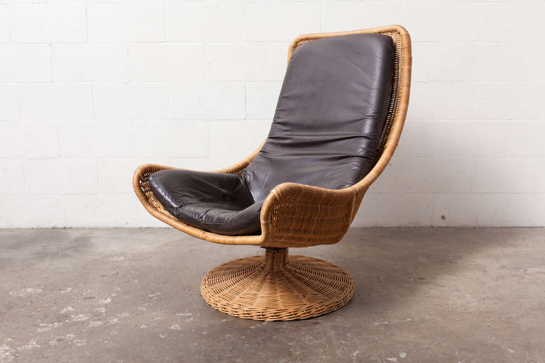 Woven Narrow Rattan Chair Sling and Base with Dark Brown Leather-Upholstered Cushion.
