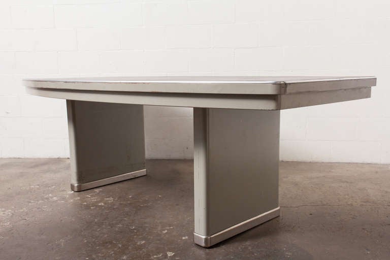 Impressive Grey Enameled Metal Frame with Curved Dark Grey Linoleum Top. Original Condition with Visible Scratching to the Top. Can be Used as a Conference Table, Extra Large Dining Table, or Executive Desk.