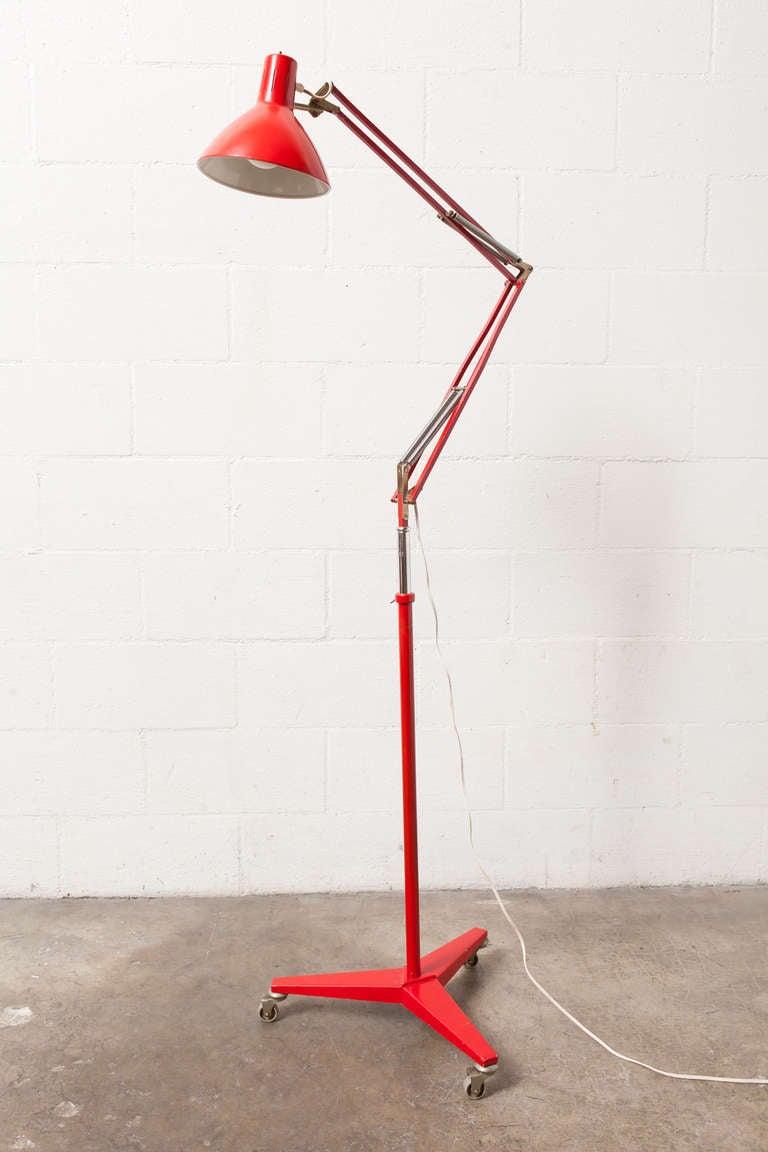 Great Midcentury Rolling Industrial Drafting Lamp in Red Enameled Metal with Adjustable Height.
