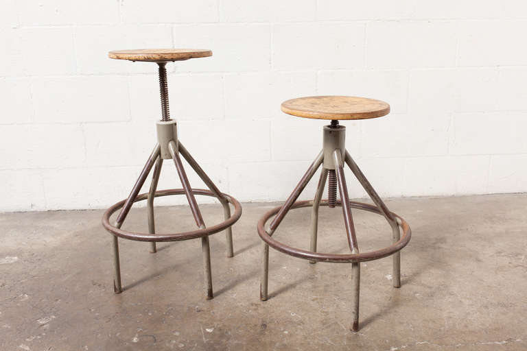 Enameled Metal Frame with Footrest and Cool Vintage-Looking Wear. Round Plywood Seat and Adjustable Height.