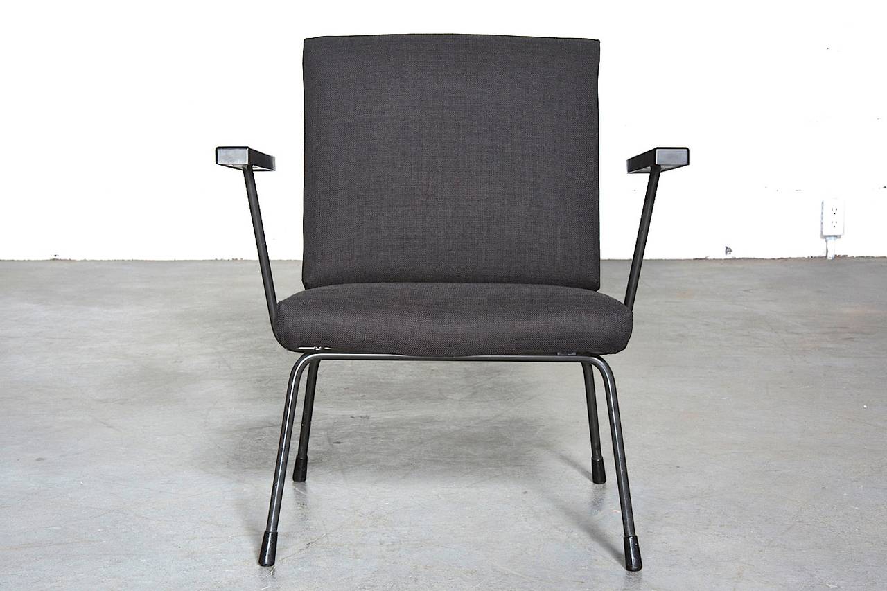 Wim Rietveld for Gispen lounge chair with original almost black enameled wire frame and bakelite armrests with new matching upholstery. Original Gispen tag still on frame. Small stature. Frame is in original condition with wear to black enamel.