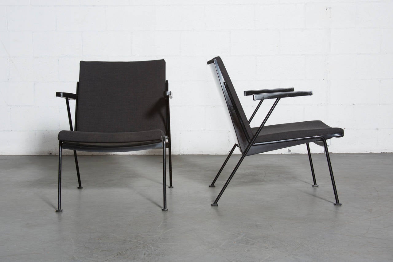 Ahrend de Cirkel Oase lounge chairs by Wim Rietveld. Black enameled frame with new nearly black upholstery and black bakelite armrests. Some visible wear to enamel. Set price.