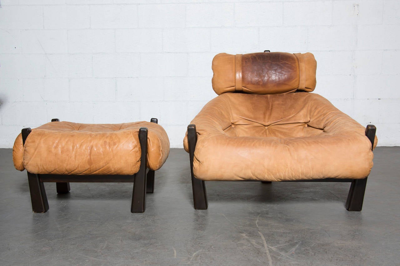 Gerard van den Berg Lounge Chair for Montis, 1970-72. Caramel Colored Leather with Great Patina and Heavy Tripod Base Frame. Smart Tension Strap Support System. In the Style of Percifal Lafer. Genius Design. Ottoman Measures 29 x 25 x 16.25. Sold as