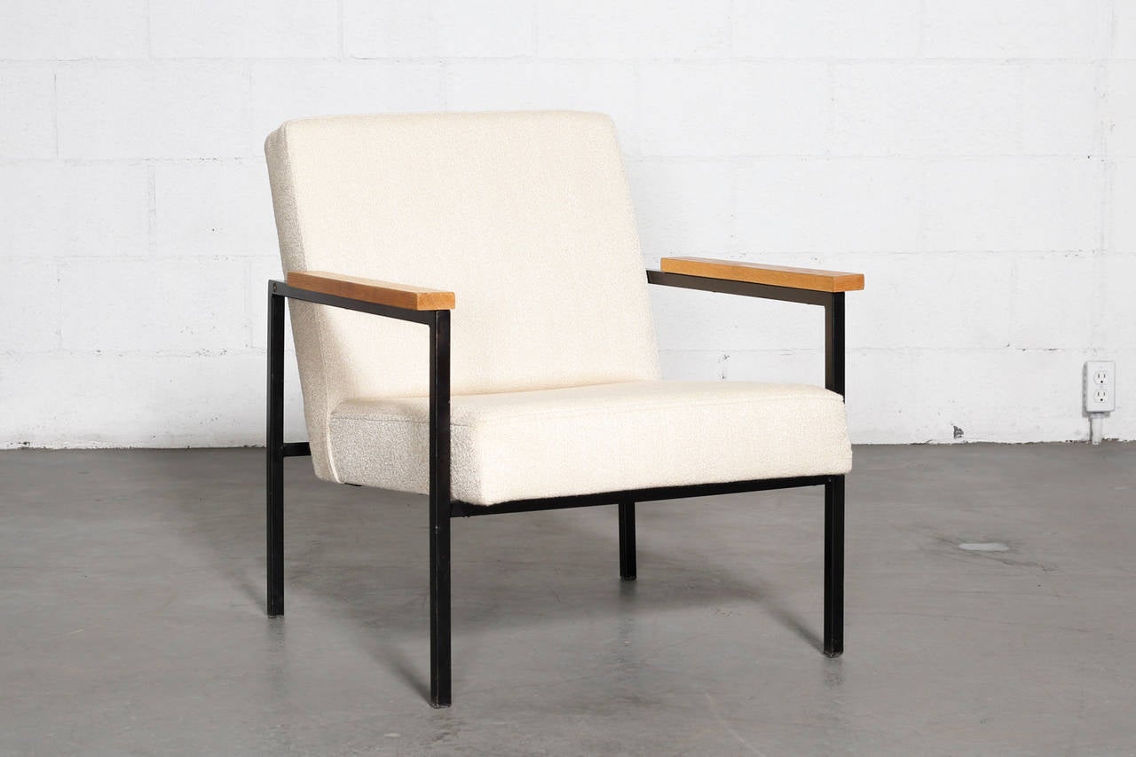 H. Stolle lounge chairs with black enameled metal frame and wood armrests and new bone upholstery. Frame in original condition with some scratching consistent with its age and usage.