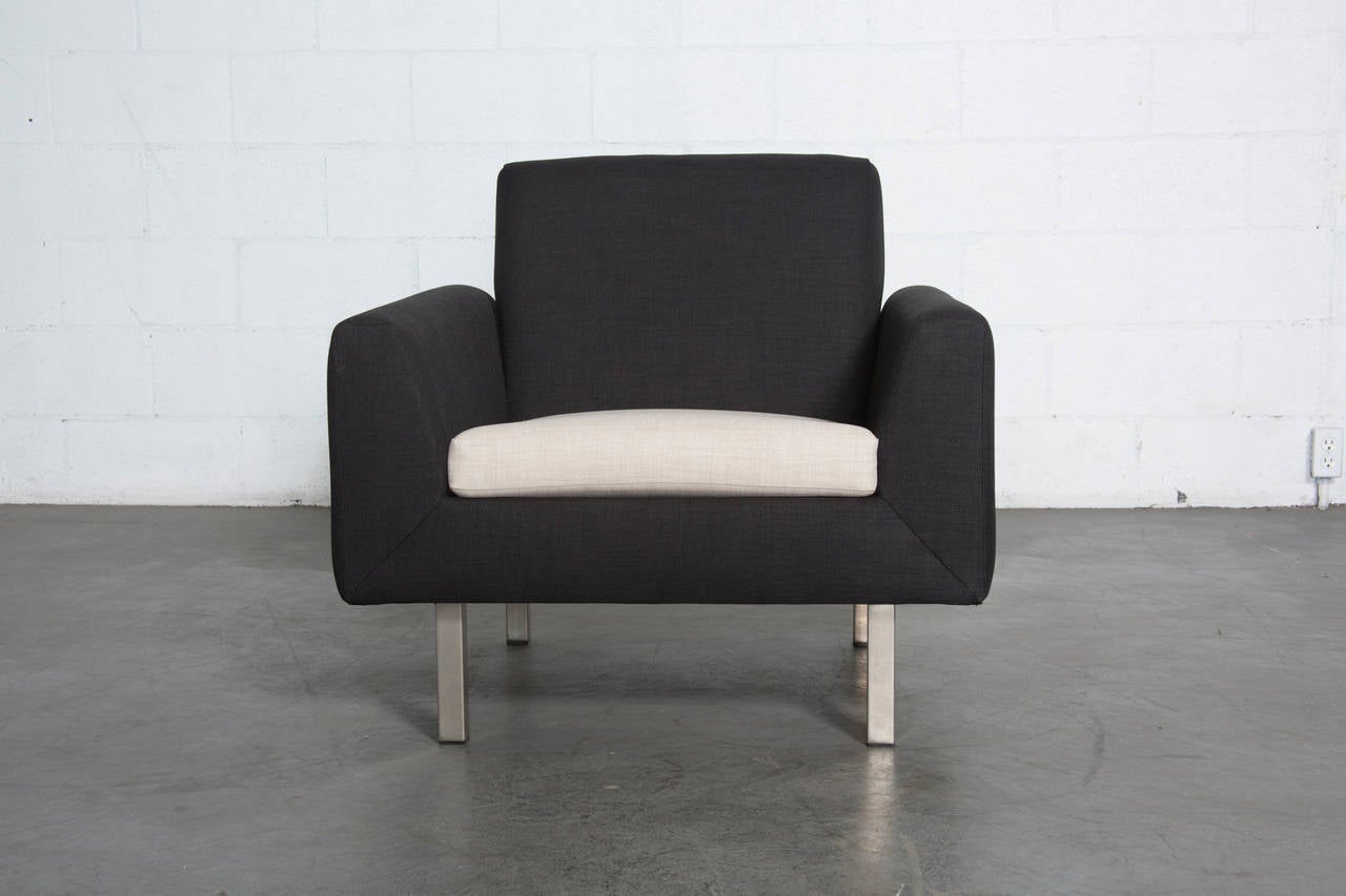 Produced in the 1960's, this low profile and almost minimalist mid-century club chair by Dutch manufacturer Artifort was re-upholstered in almost black fabric with bone seat and steel legs. Otherwise in original condition with some age appropriate