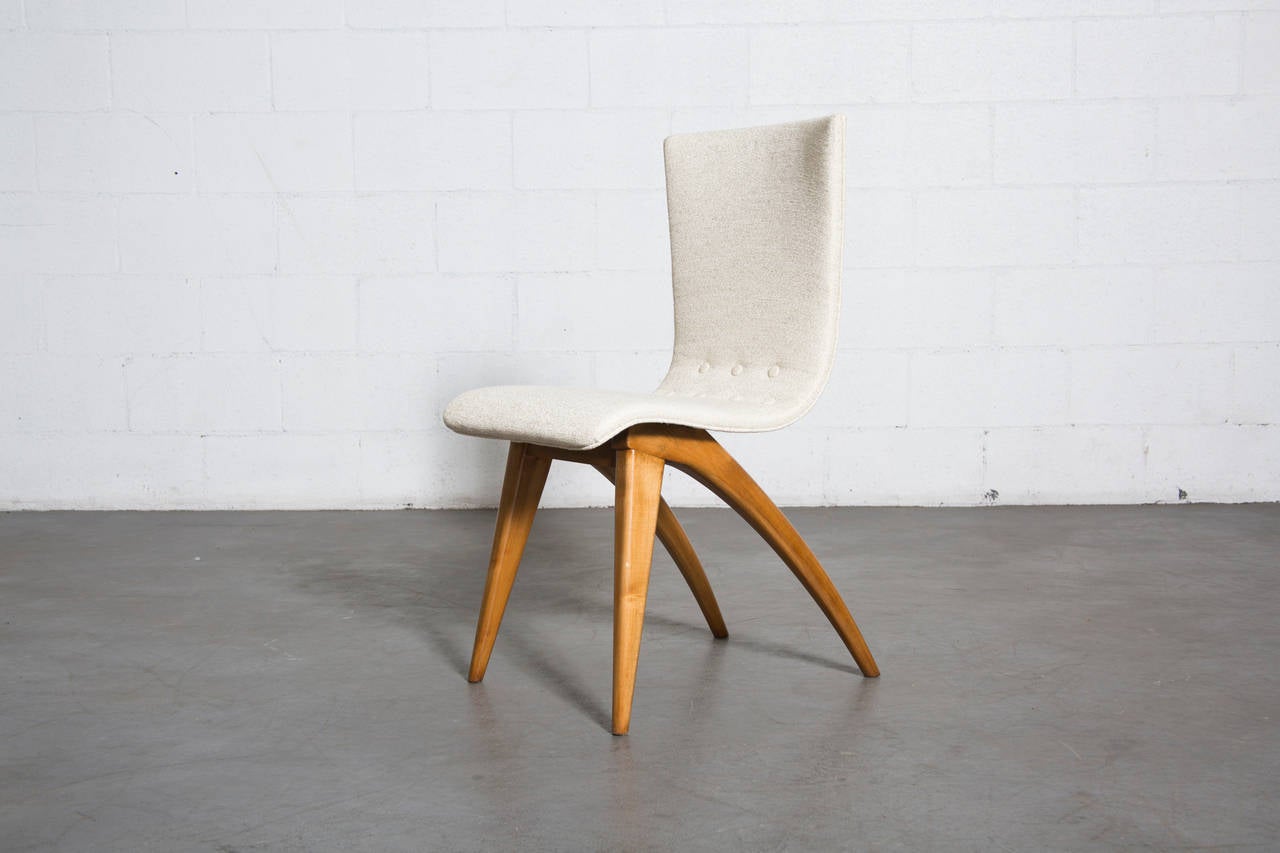 Beautiful swooping upholstered dining chairs by Van Os Culemborg in bone white upholstery and crazy cool birch legs.