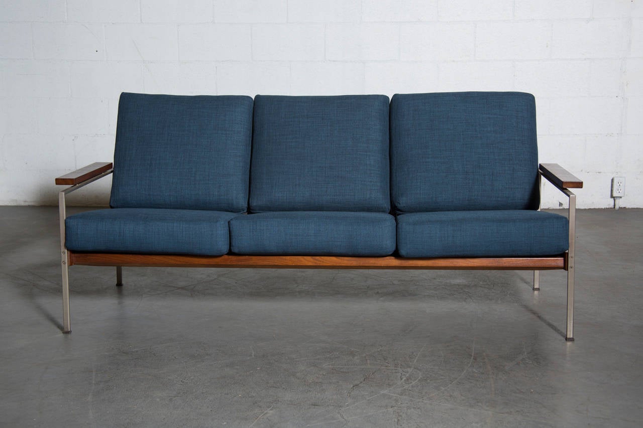 Robert Parry Sofa with Finished Teak Frame, Brushed Aluminum Legs, and Wood Armrests. Newly Made Indigo Cushions. Frame is Original with Some Signs of Wear Consistent with Age and Use. Has a Pair of Matching Lounge Chairs Sold Separately.