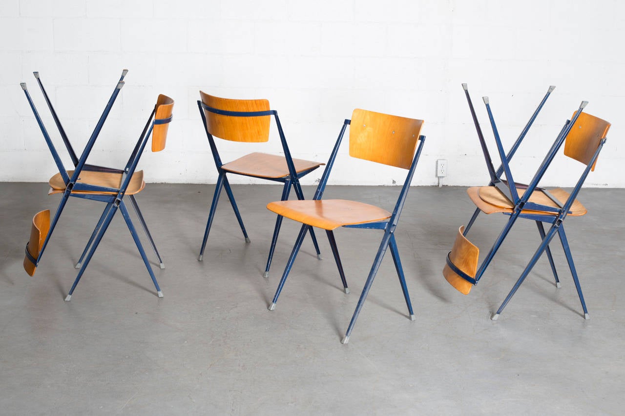 This rare chair won a famous ‘Signe d’Or’ design award in 1960. These folded sheet metal framed chairs are from the first series and have a sturdy teak seat and back. An extremely durable and comfortable chair. This set of six stacking chairs has a