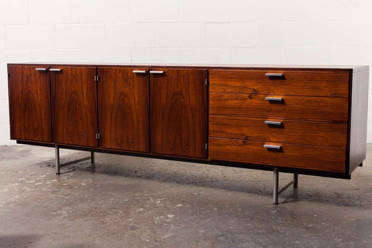 Beautiful Rosewood Grain, Extra Long Streamlined Credenza with Brushed Chrome Pulls. Has a Plastic Drawer.