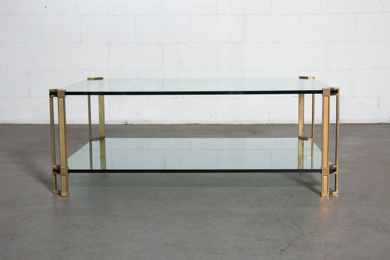 Double tiered, exceptionally large brass and glass coffee table with oriental influence. Peter Ghyczy studied architecture with an Industrial Design background at the Polytechnic University Aachen and is recognized for his famous 1968 garden egg