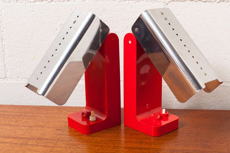 Red Model 4034 Folding Table Lamps for Kartell, 1968, in Plastic and Polished stainless steel with twin light bulbs and sequential light switch in Original Condition. One has some heat damage, slight wave on front panel, and a green felt bottom
