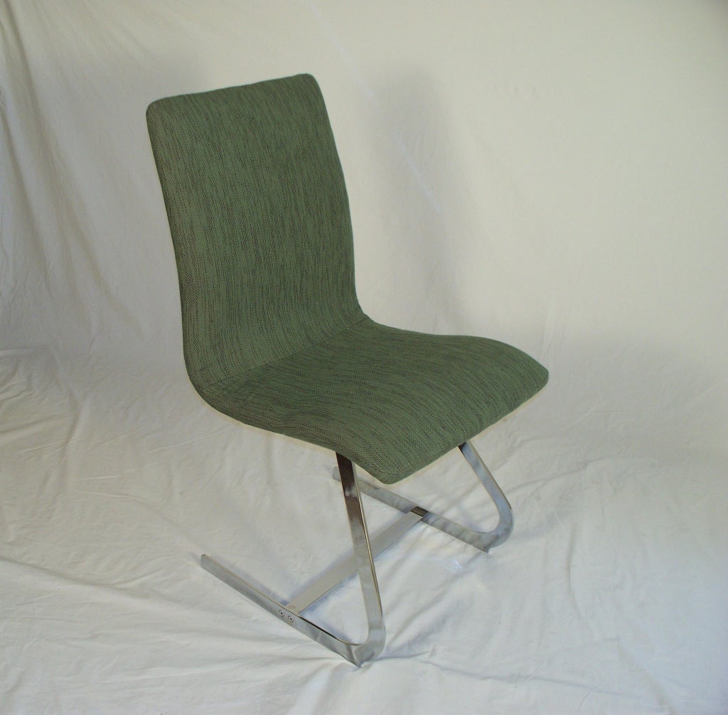 Pair of dining/side chairs by Richard Young for Merrow Associates. Steel chrome-plated angled legs and green jacquard upholstered floating seat, circa 1960.