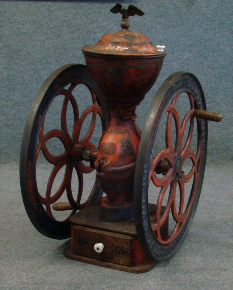 Enterprise No. 209 coffee grinder, with original orange and black paint and original stenciling. 

The coffee grinder boasts 25