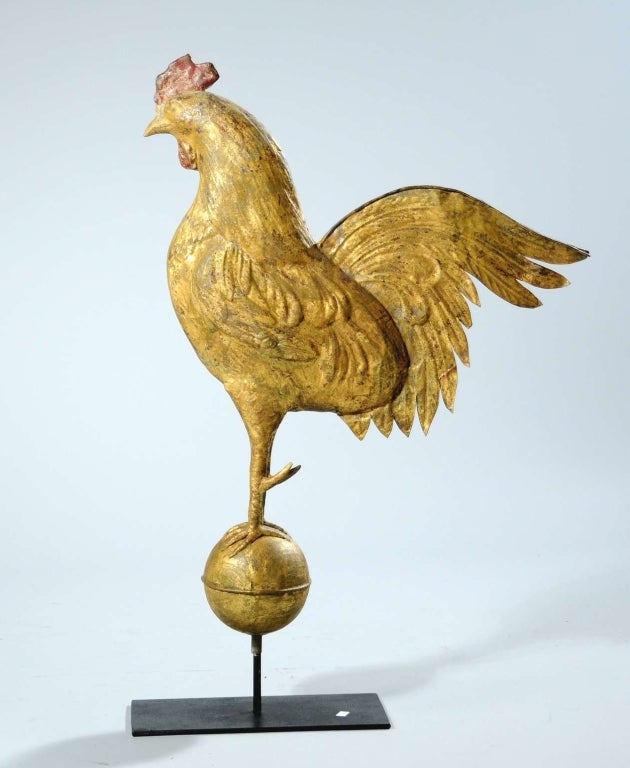 Large copper rooster weathervane, original gilt, perched on a gilded copper ball. The weathervane has excellent patina and beautiful detailing. Late 19th century, American. Guaranteed to be old.

Dimensions: 26” high, (31” including stand), x 21