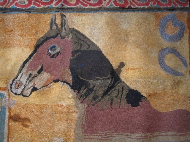 Spectacular hooked rug, depicting a horse along with a well sweep, a horseshoe, a horse collar, and several other equine items. One can't help smiling at the horse's expression and long eyelashes. <br />
<br />
This is a joyous piece of folk art