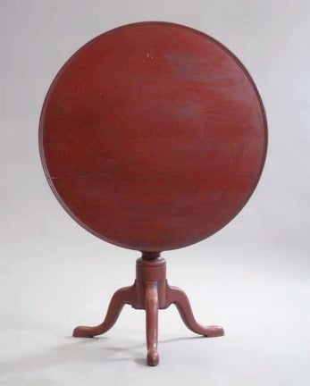 Queen Anne tilt-top tea table. The table has 19th century red paint over the original red paint. The round top has an attractive molded, raised edge. The table dates from circa 1790-1800.