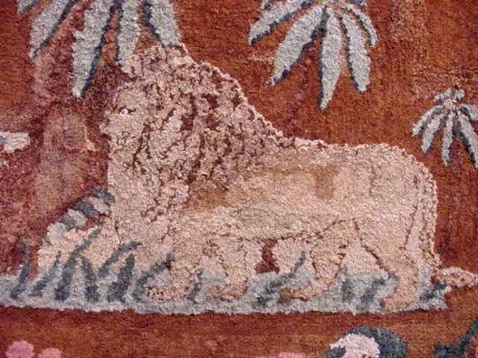 Wonderful hooked rug, depicting a lion amongst palm trees, with shields in each of the four corners. Lovely colors. Some repair. Most likely an E.S. Frost pattern. The rug is mounted on a wooden frame. Last half of the 19th century, New England