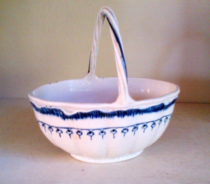 Beautiful pearlware strawberry basket, named such by Josiah Wedgwood.  The Mared pattern is rare and forms a chain below the cobalt blue shell edge. Twisted handle and basketweave embossed exterior. The mark is shown on the base; Wedgwood always