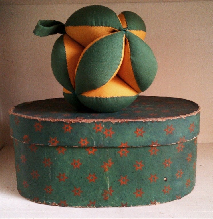 Pennsylvania craftsman were superb at wallpaper-covered boxes and pincushions.  The puzzle ball, so named,is a visual and colorful form in typical colors of green and mustard yellow; the early wallpaper box, a salmon star on a forest green