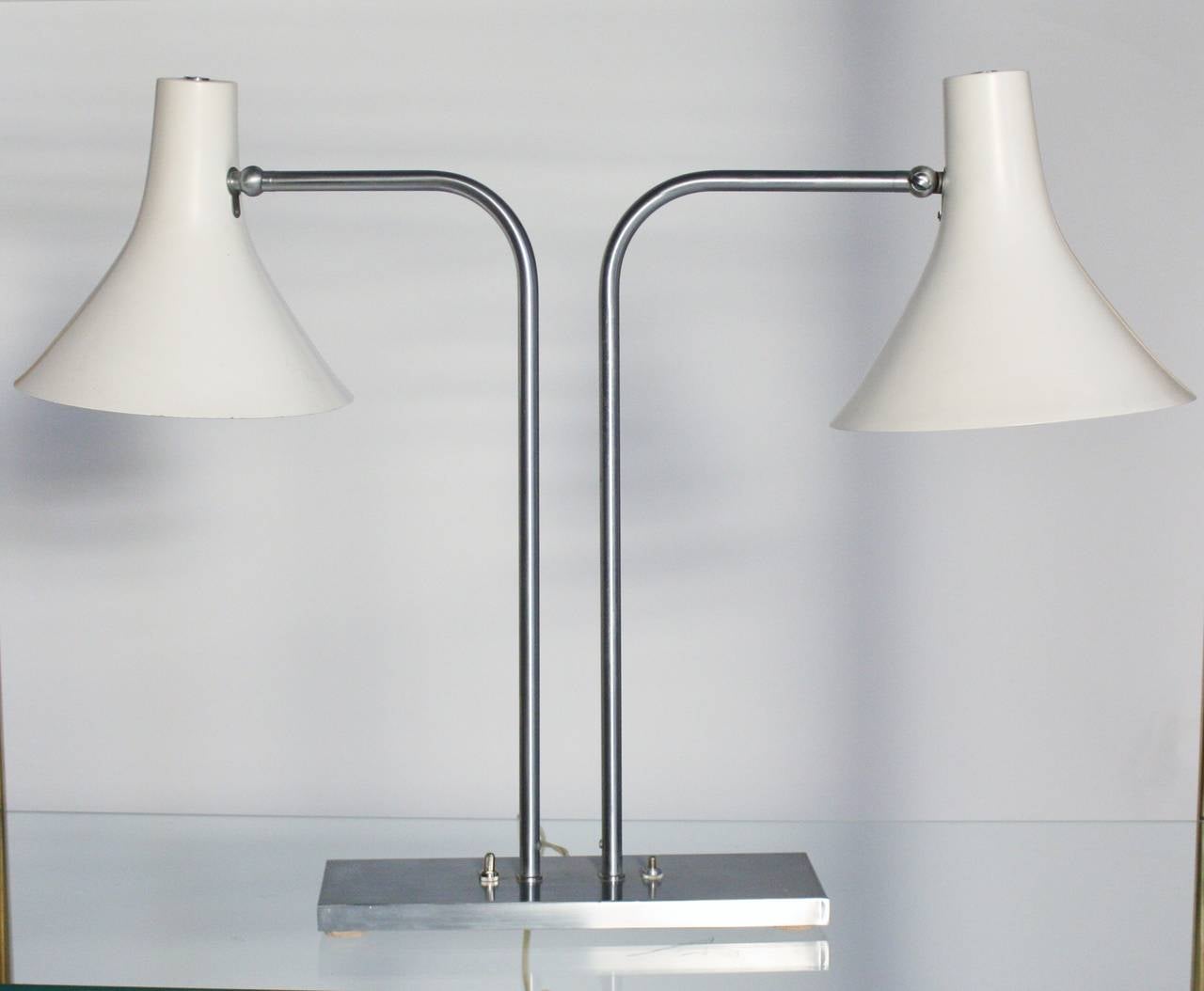 Iconic mid-century modern desk lamp by Greta Von Nessen in sought-after two-shade swivel style and brushed nickel arms. Each shade operates by a separate switch. Wired and in working condition.