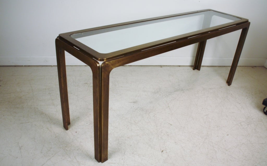 Long bronze metal sofa table or console with a glass top attributed to Mastercraft, 1960s.