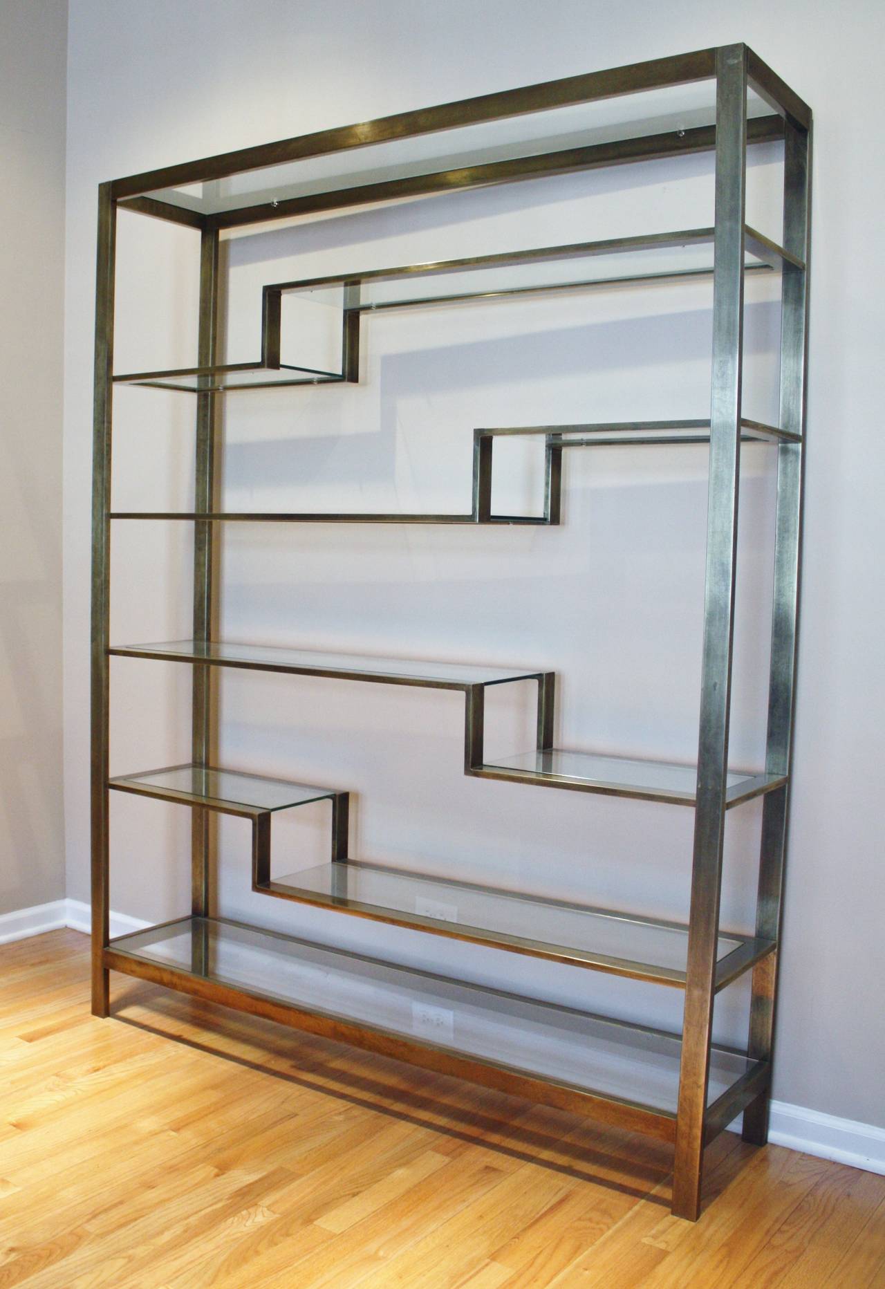 Large brass etagere in a bronze/brushed gold finish by Romeo Rega with 10 glass shelves.