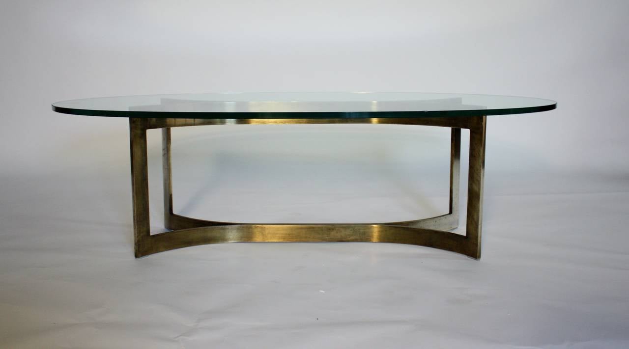 Mid-Century modern solid bronze and glass oval cocktail table by Baker.