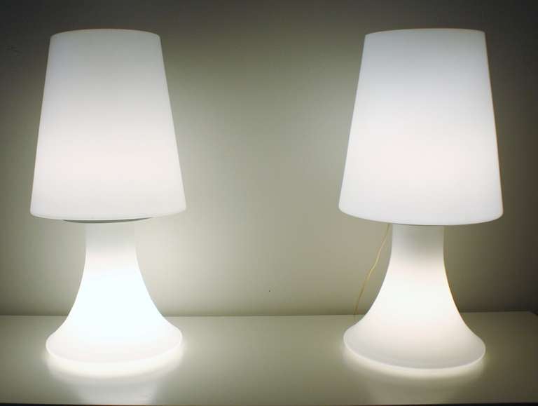 1960s Italian white glass lamps illuminate through both the base and glass shades. Each are wired with dimmer switches.